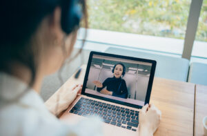 Woman using a laptop for video call with Castlight Care Guide