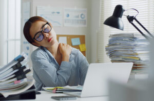 woman stressed and burnt out in office setting