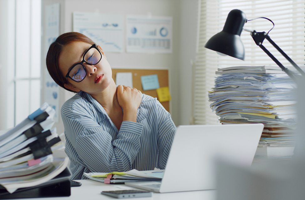 woman stressed and burnt out in office setting