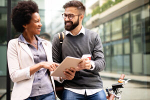 Happy business people discussing and smiling while walking together outdoor