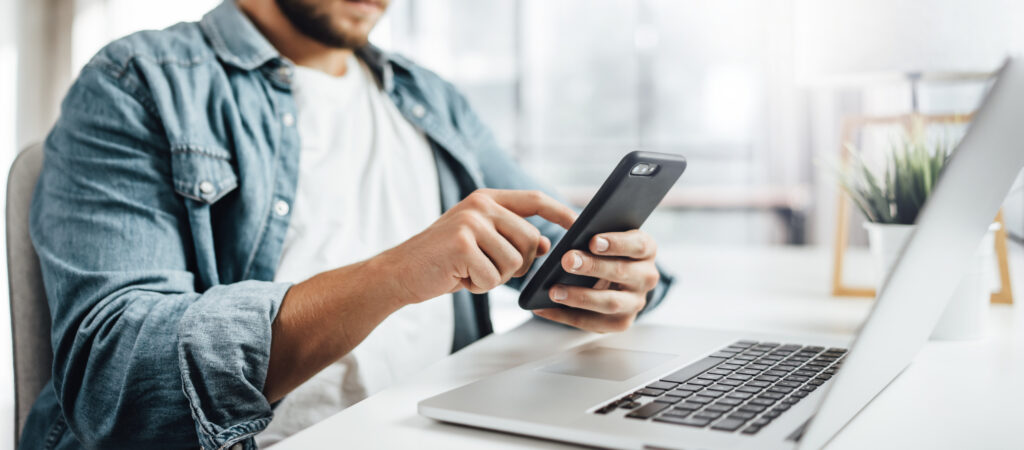 Employee reviewing multiple benefits apps on a smartphone.
