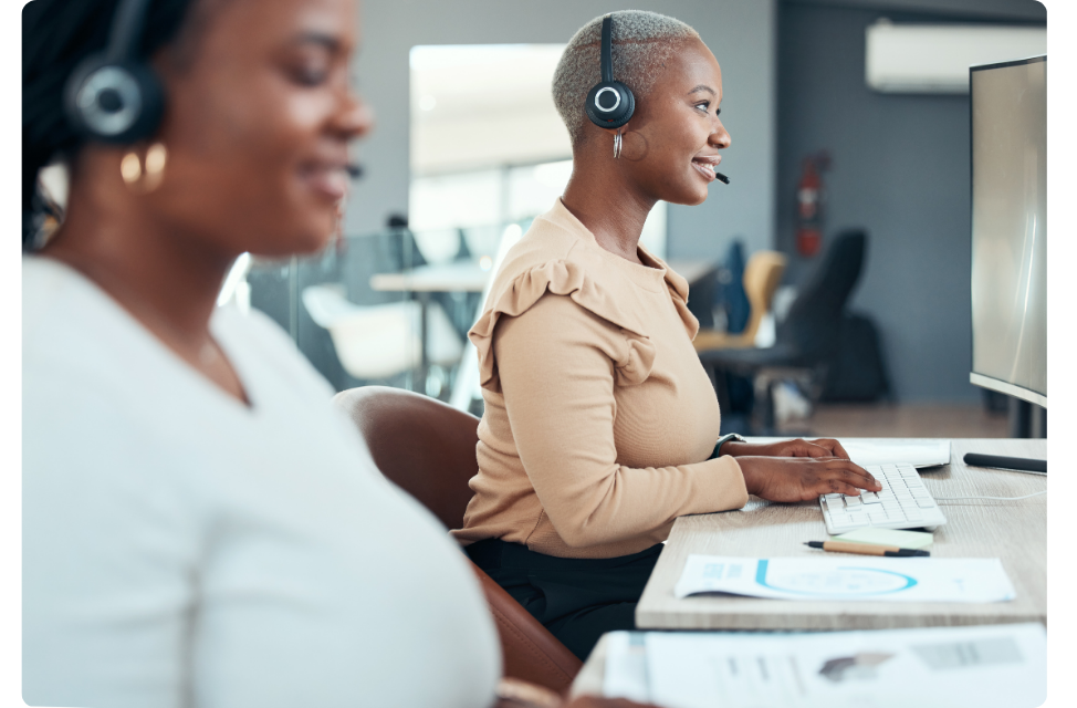 Care guides in office on headset assisting Castlight members